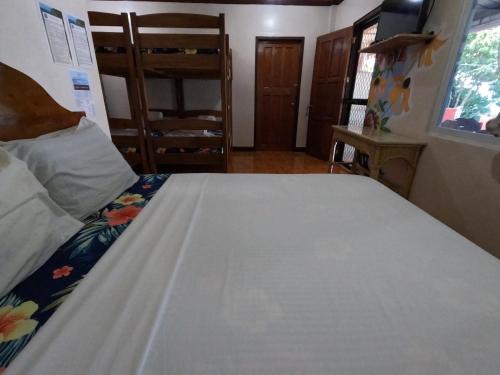 a bedroom with a large white bed in a room at Gratum Beach Resort in Dapitan