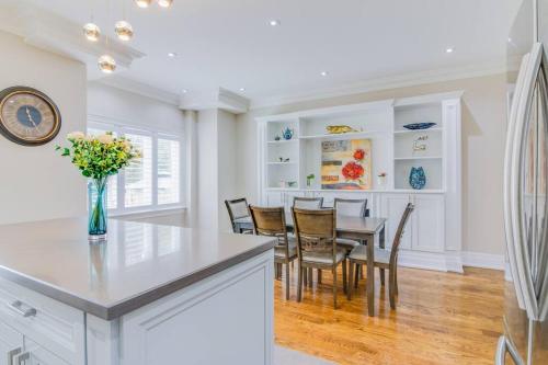 a kitchen and dining room with a table and chairs at Luxury house, 25 minutes to Toronto Downtown in Toronto