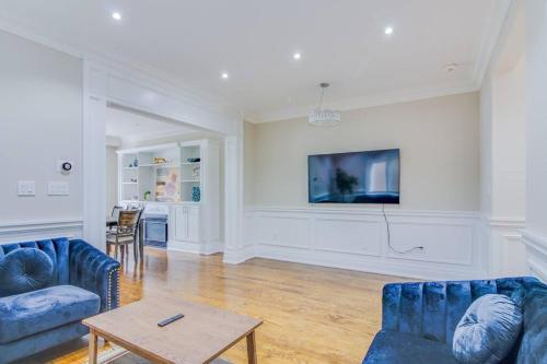 a living room with two blue couches and a table at Luxury house, 25 minutes to Toronto Downtown in Toronto