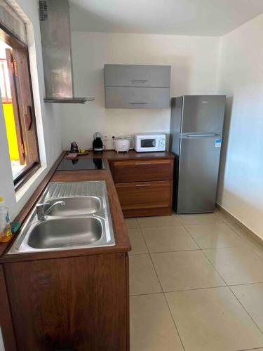a kitchen with a sink and a refrigerator at Mana - SRFB 1 in Mana