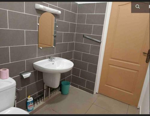 a bathroom with a sink and a toilet at Mana - SRFB 1 in Mana