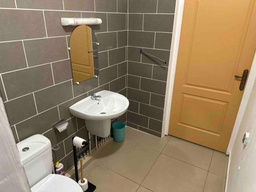 a bathroom with a sink and a toilet and a mirror at Mana - SRFB 1 in Mana