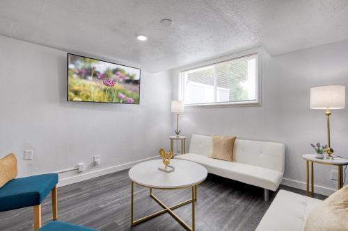 a living room with a couch and a table at New Downtown Boise on Bsu Campus 3 Beds Sleeps 6 in Boise
