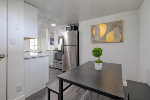 a kitchen with a table and a stainless steel refrigerator at New Downtown Boise on Bsu Campus 3 Beds Sleeps 6 in Boise