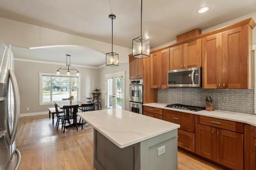 a kitchen with wooden cabinets and a dining room at New Skagit Sunset Birdsview, Concrete, WA in Concrete