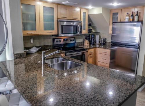 a kitchen with a sink and a stove at Penthouse Suite Downtown, Top Floor 4 Beds, 2Baths in Seattle