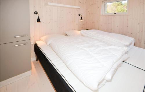 a white bed in a small room with a window at Cozy Home In Ebeltoft With Wifi in Ebeltoft