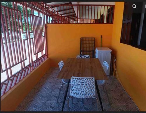 a room with a wooden table and chairs andwindows at Mana - SRFB 3 in Mana
