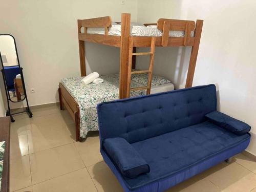 a living room with a blue couch and a bunk bed at Mana - SRFB 3 in Mana
