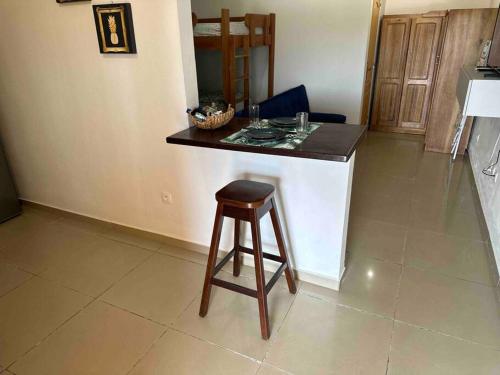 a kitchen with a counter and a stool in a room at Mana - SRFB 3 in Mana