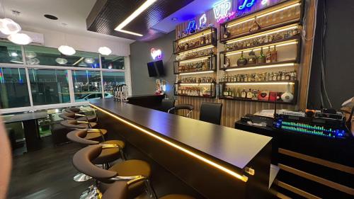 a bar with a long counter in a restaurant at Alongkorn hotel by SB in Samut Songkhram