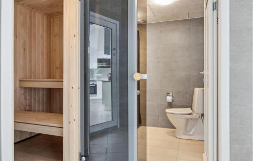 a bathroom with a toilet and a glass door at Aqua 221 in Krakow am See