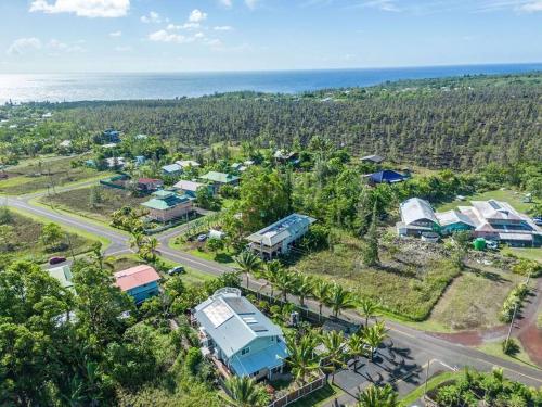 an aerial view of a resort with the ocean at Pahoa Tropical Garden Getaway in Pahoa
