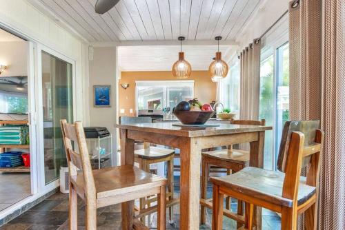 a kitchen with a wooden table and chairs at Pahoa Tropical Garden Getaway in Pahoa