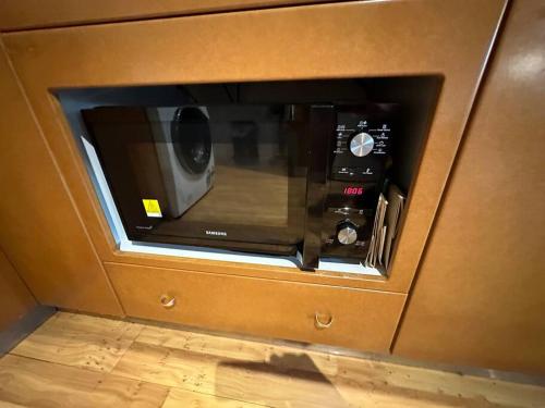 a microwave oven in a kitchen with its door open at Pete's Place in Berrimah
