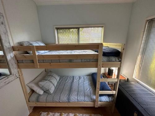 two bunk beds in a room with a window at Pete's Place in Berrimah