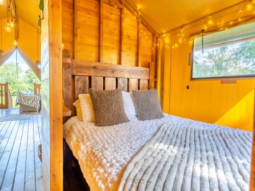 a bedroom with a bed in a wooden house at The Owls Hollow - Uk45297 in Bishop Thornton