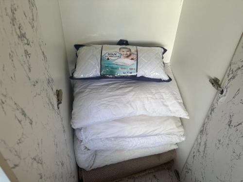 a small bed with a book on top of it at LovelyStay - Luxury & proximity to Corniche and TGV in Tangier