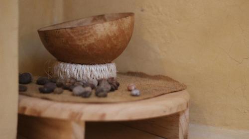 a bowl sitting on a table with rocks on it at Hostel Boutique 55 in San Cristóbal de Las Casas