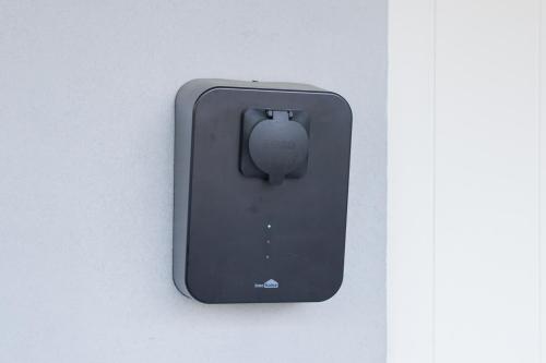 a black computer mouse is attached to a wall at Villa Rajaportti 1st&2nd floor Loft with lakeview and free front door parking with electric car plug in Tampere