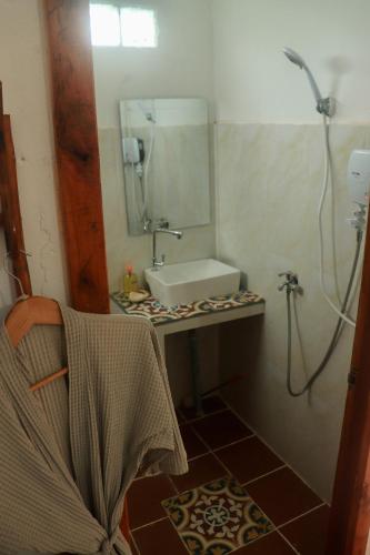 a bathroom with a sink and a mirror at Beach House Cambodia in Koh Rong Sanloem