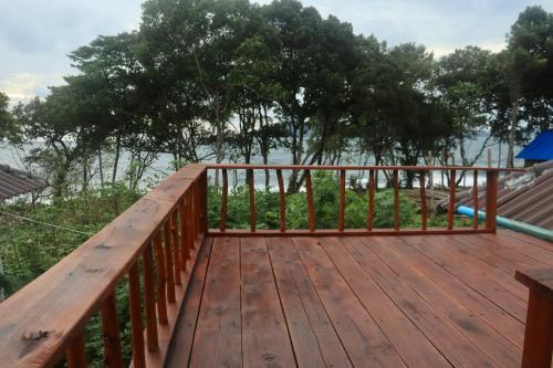 a wooden deck with a view of the water at Beach House Cambodia in Koh Rong Sanloem