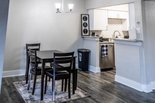 a kitchen with a table and chairs in a room at Walk to WorldCup Dallas At&t Stadium from Cozy 2bd2ba Apartment in Arlington