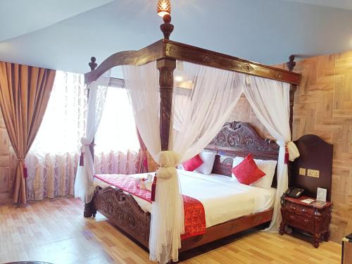 a bedroom with a canopy bed with curtains at HYDERS PARK- THE LUXURY HOTEL in Kodaikānāl