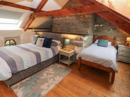 a bedroom with two beds in a attic at Ty Llwyd in Eglwyswrw