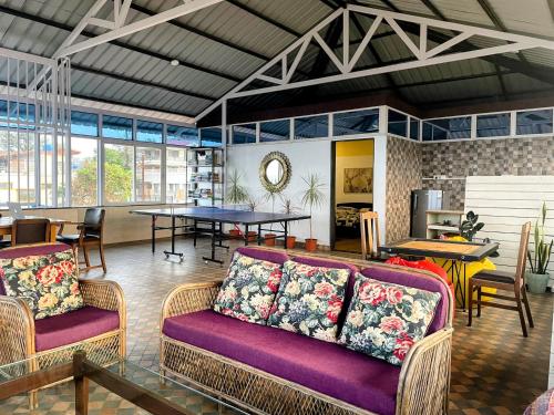 a living room with two couches and a table at The Loft in Panchgani
