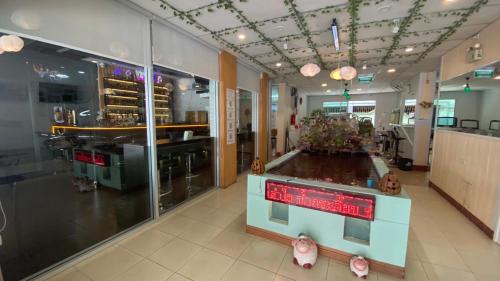 a store with a counter in the middle of a room at Alongkorn hotel by SB in Samut Songkhram