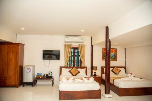 Postel nebo postele na pokoji v ubytování PHƯƠNG NHUNG HOTEL