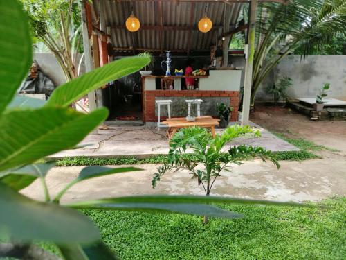 an outdoor patio with a table and a bar at Galle Wonvil Apartment in Galle