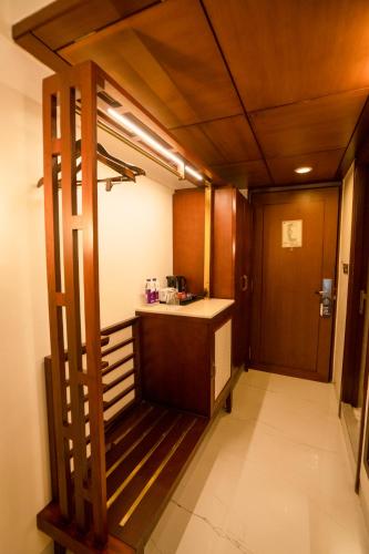 a room with a kitchen with a counter and a door at Evershine Resort & Spa in Mahabaleshwar