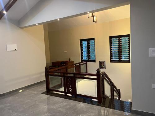 a room with a staircase and a mirror at Chaithanya Residency in Kunnamangalam