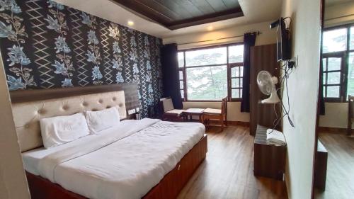 a bedroom with a large bed in a room at Shimla Royale - Near Mall Road Free Pickup From Railway Station Shimla in Shimla