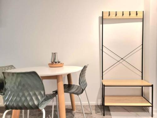 a dining room table with two chairs and a mirror at CBD 2BDR 2Bath Casino TownHall TePae Convention center FREE carpark in Christchurch