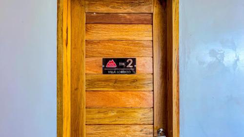 a wooden door with a sign on it at Caliraya Heights Resorts and Events Place in Halang