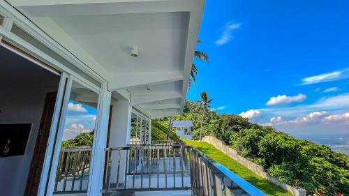a balcony of a house with a view of the ocean at Caliraya Heights Resorts and Events Place in Halang