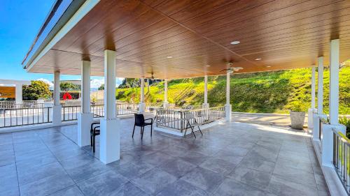 a covered porch with a table and chairs on it at Caliraya Heights Resorts and Events Place in Halang