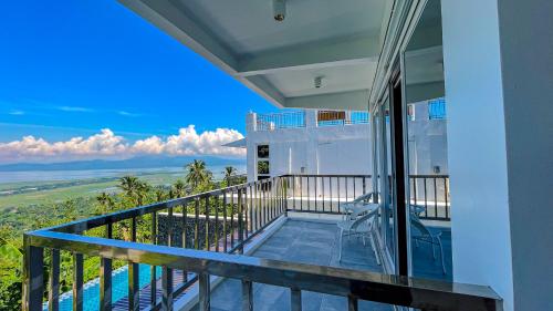 a balcony of a house with a view of the ocean at Caliraya Heights Resorts and Events Place in Halang