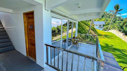 a balcony of a house with a view of a yard at Caliraya Heights Resorts and Events Place in Halang