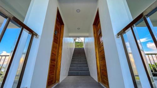 a staircase in a house with wooden doors and windows at Caliraya Heights Resorts and Events Place in Halang