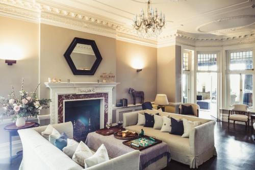 
a living room filled with furniture and a fireplace at Merchants Manor Spa in Falmouth
