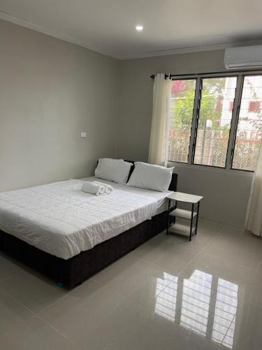 a bedroom with a large bed and a window at Two Bedroom Holiday Home- Olosara Sigatoka Guest House in Singatoka