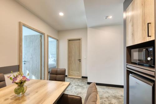 a dining room with a table and a microwave at Expocore Hotel in Yerevan