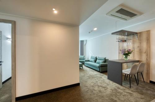 a living room with a couch and a table at Expocore Hotel in Yerevan