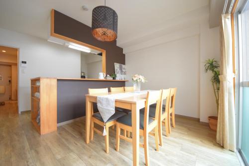 a dining room with a table and chairs at Comfy Stay TDS in Nara