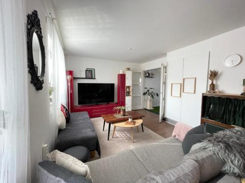 a living room with a couch and a table at Your Perfect Aarhus Staycation in Aarhus