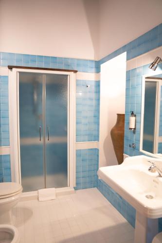 a bathroom with a shower and a toilet and a sink at Relais Santa Caterina Hotel in Viterbo